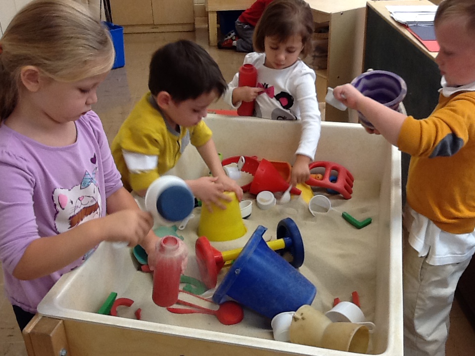 Brian engages in play at the sand table.
